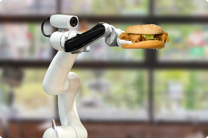 brazo robotico sosteniendo una hamburguesa